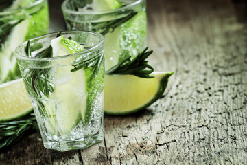 Refreshing drink with rosemary, lime and honey on the old wooden