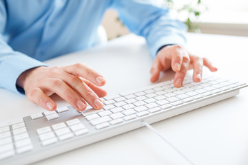 Men office worker typing on the keyboard