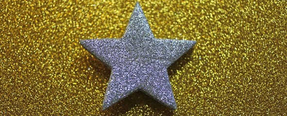 big silver star in the glittering yellow background