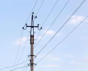 Mast electrical power line against cloud and blue sky