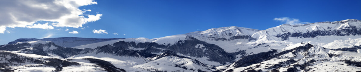 Fototapeta na wymiar Panoramic view on snowy mountains at nice sun day