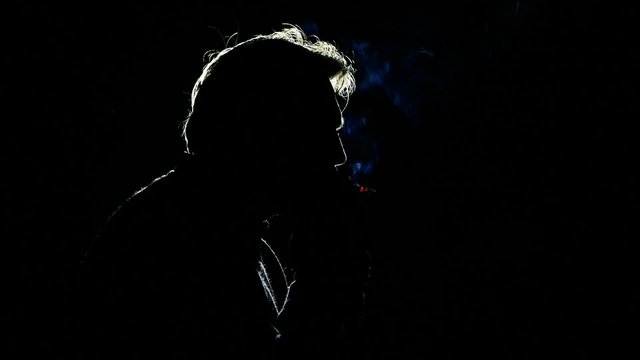 Tobacco smoker man male smokes a cigarette, person silhouette in nicotine poison blue smoke