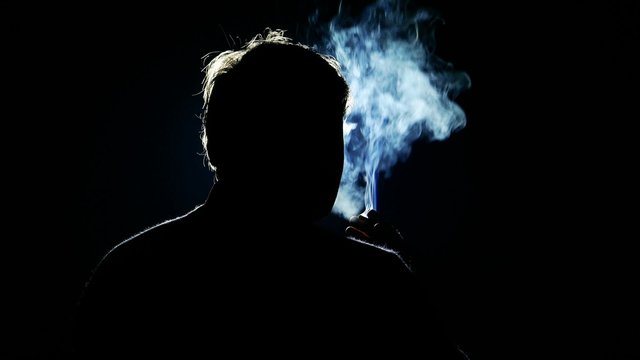 Tobacco smoker man male smokes a cigarette, person silhouette in nicotine poison blue smoke