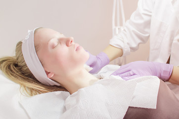 Pretty woman receiving facial treatment