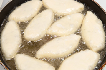 Food patties in a frying pan