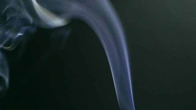 Tobacco cigarette nicotine poison blue smoke on a black background