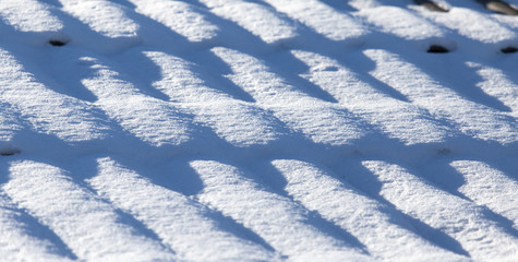 Fototapeta na wymiar Snow on the roof of a house as a background
