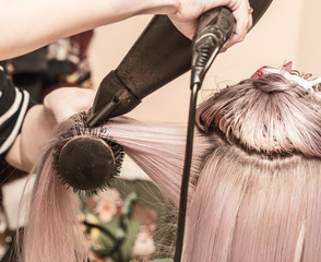 Naklejka premium blow-drying hair in a beauty salon