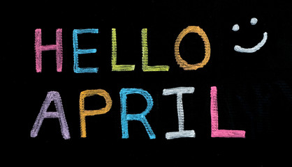 Fototapeta na wymiar Hello April written on blackboard