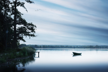Rowing boat floating over the Lake Elk waters. Masuria, Poland.