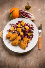 fried chicken wing with chicory salad and orange