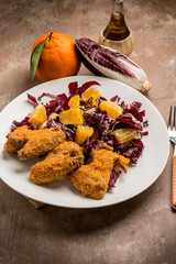 fried chicken wing with chicory salad and orange