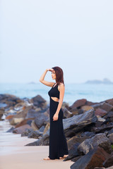 Portriat of Young redhead woman in a black dress