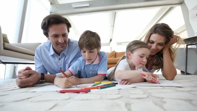 Smiling family drawing together 
