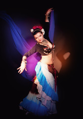 Fototapeta premium Beautiful exotic belly tribal dancer woman with blue shawl