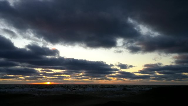 Time lapse sunset with clouds over lake 