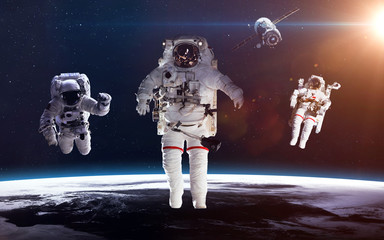 Astronaut in outer space against the backdrop of the planet earth. Elements of this image furnished...