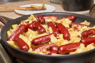 Fried potatoes with sausages