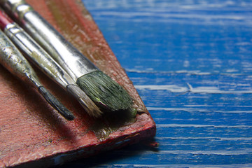 Painting tools colour palette and Artist paint brushes on abstract artistic background