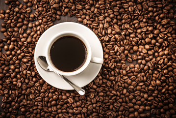 Coffee cup top view on beans background