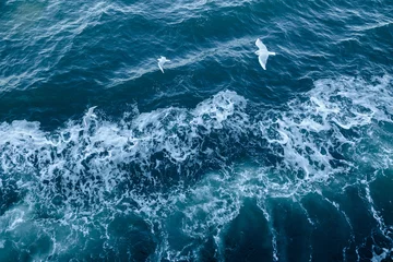 Tuinposter Blue sea texture with waves and foam © Ivan Kurmyshov