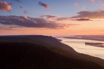 Beautiful nature mountain landscape. Cloudy sunset over river