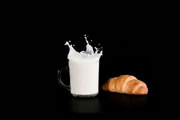 cup with milk and croissant