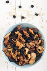 Blue plate with dried apples and berries and oatmeal 