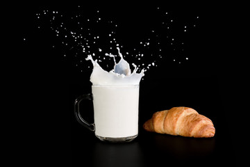 milk and croissant on a dark background