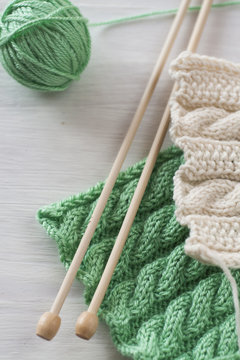 Two bright patterns and wooden knitting needles 