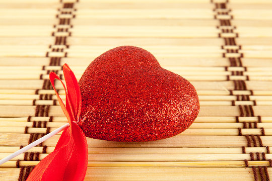 Valentine day concept - heart shaped lolly pop on wood background