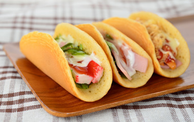  rolled pancakes stuffed ham and cheese.