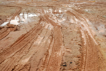 muddy road with tire trail