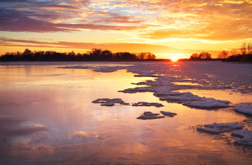 Winter landscape with sunset fiery sky. 