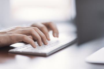 Fototapeta premium male hands typing on keyboard close