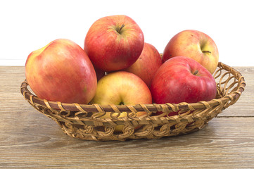 Fototapeta na wymiar apples in a basket on a wooden background
