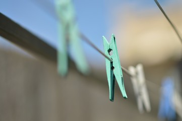 Pegs on an urban washing line (selective focus)