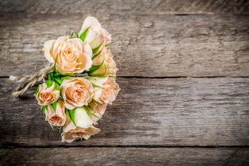 Bouquet of beige roses on wooden background