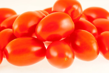 fresh red tomatoes presented on white background