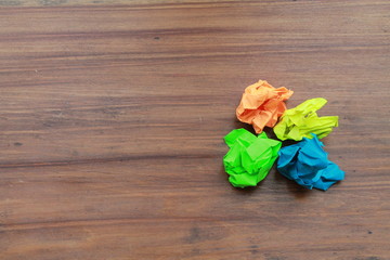 Colorful Crumpled Paper on a wood background