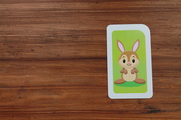 Preschool Flashcard with Little Rabbit on Wood background