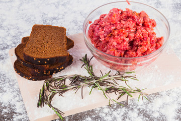 Raw minced meat with bread and rosemary