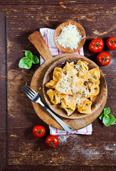 with chili peppers on a wooden table. Rustic style.filled pasta