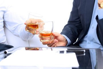 Close-up image of a contract . two colleagues celebrate signing