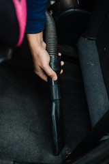 Fototapeta na wymiar Closeup on auto car service cleaning and vacuuming interior.