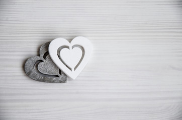 Two wooden hearts on a white background
