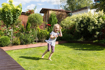 girl dancing in beautiful blooming garden
