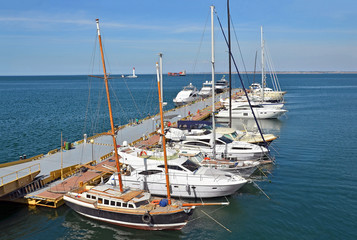 White motor yacht over harbor pier, Odessa, Ukraine