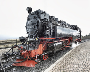 Fototapeta na wymiar historic German black steam powered railway train at Brocken station, Brocken, Harz, Germany, Europe
