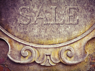 Sale written on stucco wall - concept image